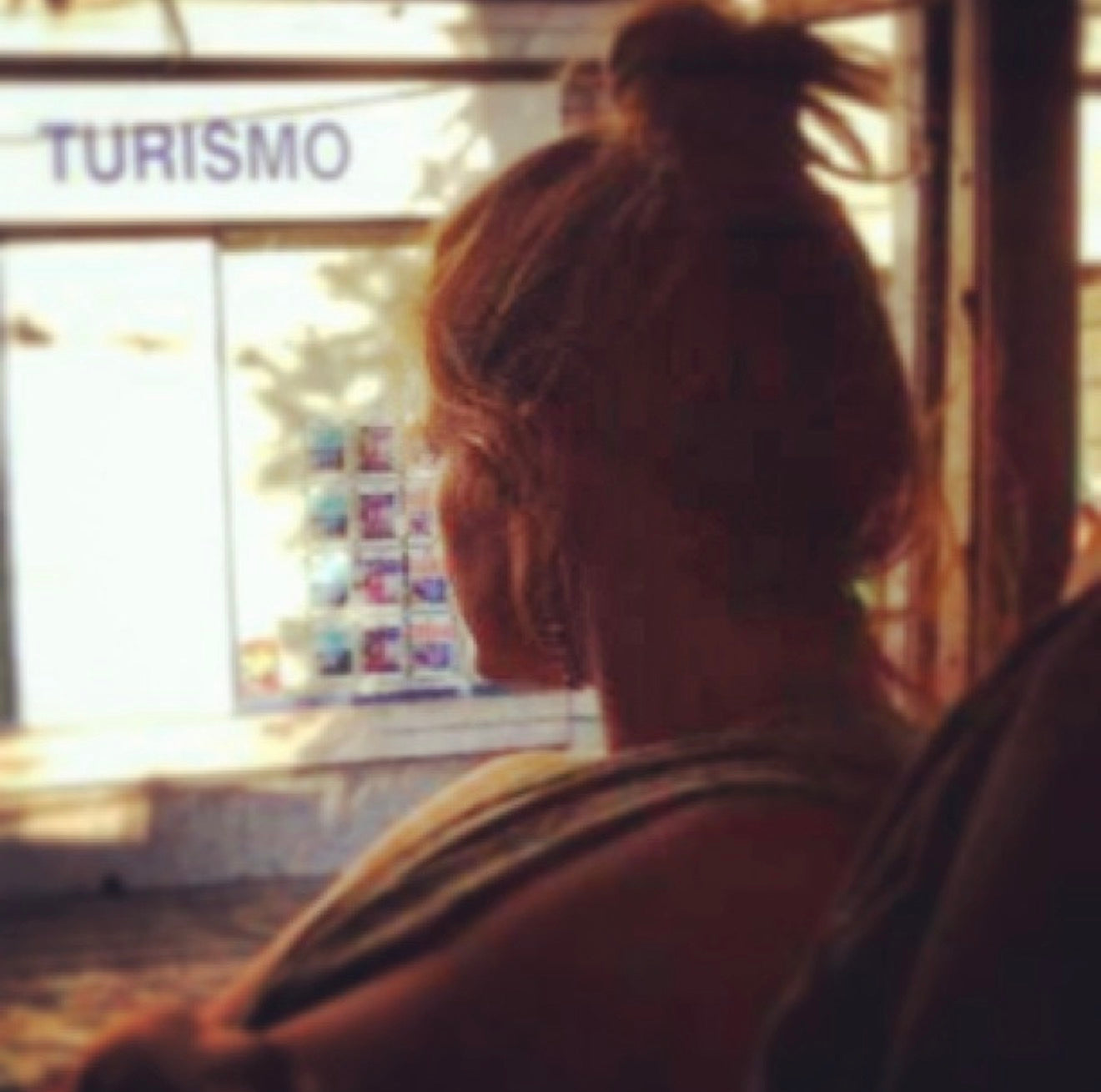 Artist peers out of a window 