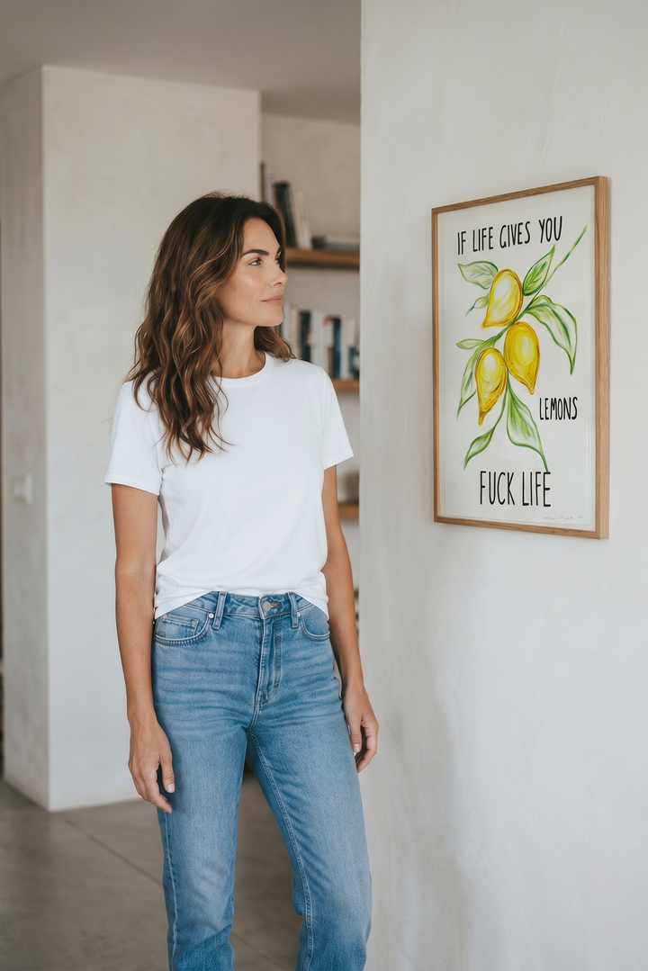 Woman standing in a room with a framed original Alma Singer  artwork on the wall.