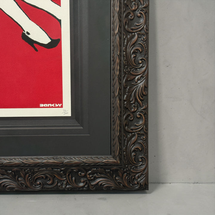 Framed artwork with ornate brown frame and red background