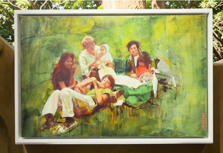 Mar Herrera’s framed ‘Familia’ oil painting (100x65cm) displayed outdoors, highlighting its vibrant green tones.