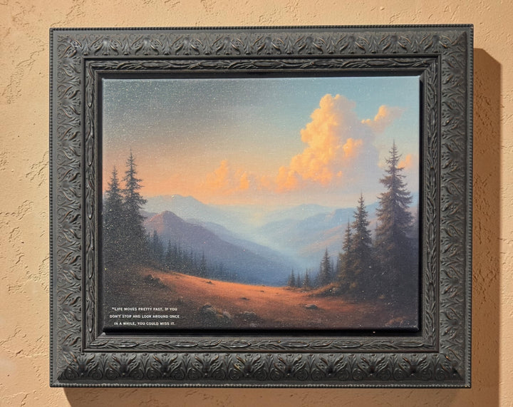 Lilly Daffu ‘Life Moves Pretty Fast’ framed mixed media mountain sunset landscape art with dusty orange road and quote.”
