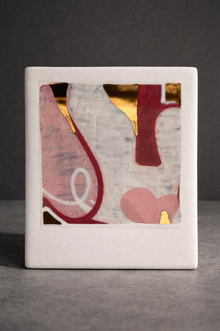Porcelain original artwork, abstract  item with abstract design of graffiti featuring pink, red, and real gold on a white porcelain against a dark background.