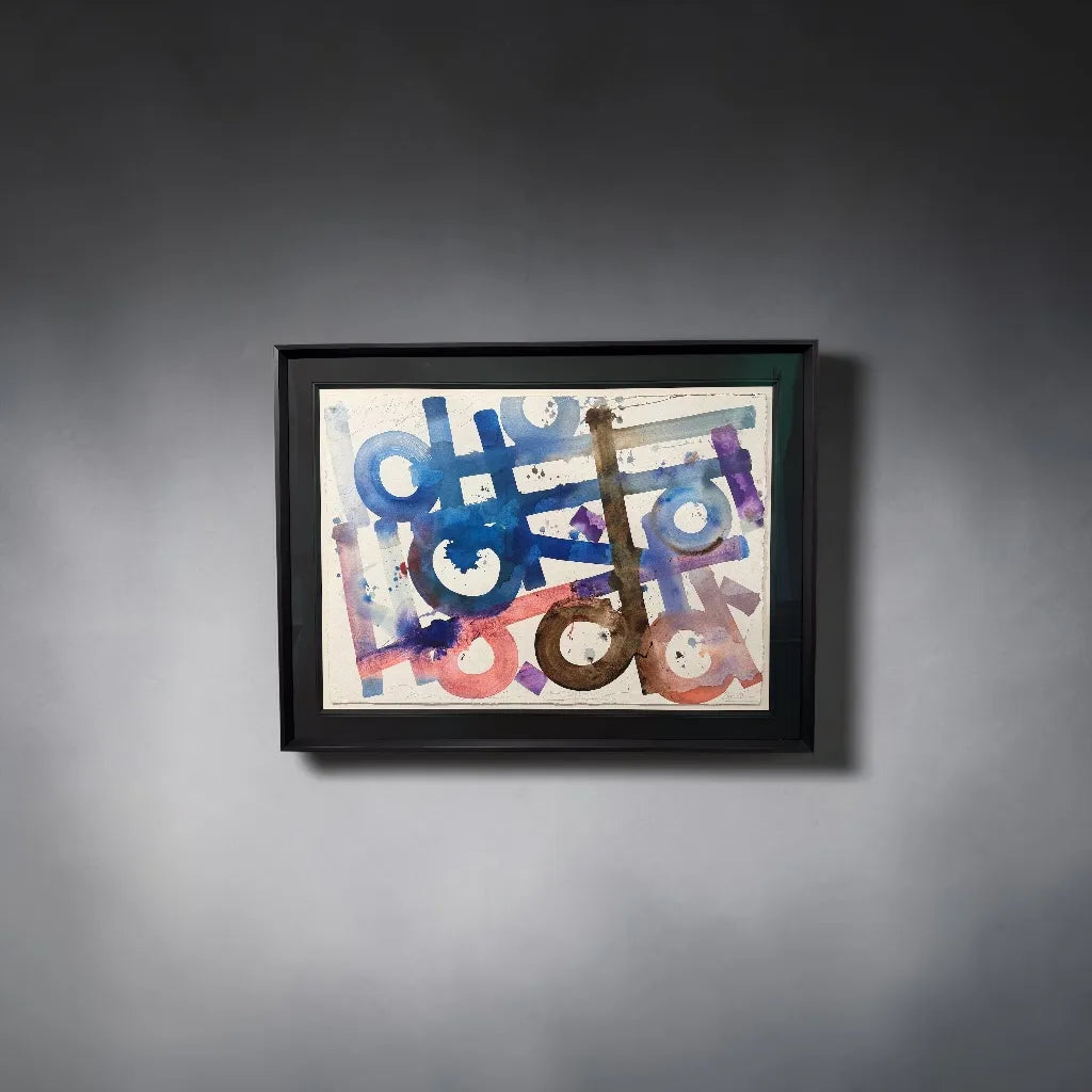 Framed abstract artwork by Retna with colorful geometric shapes on a grey wall