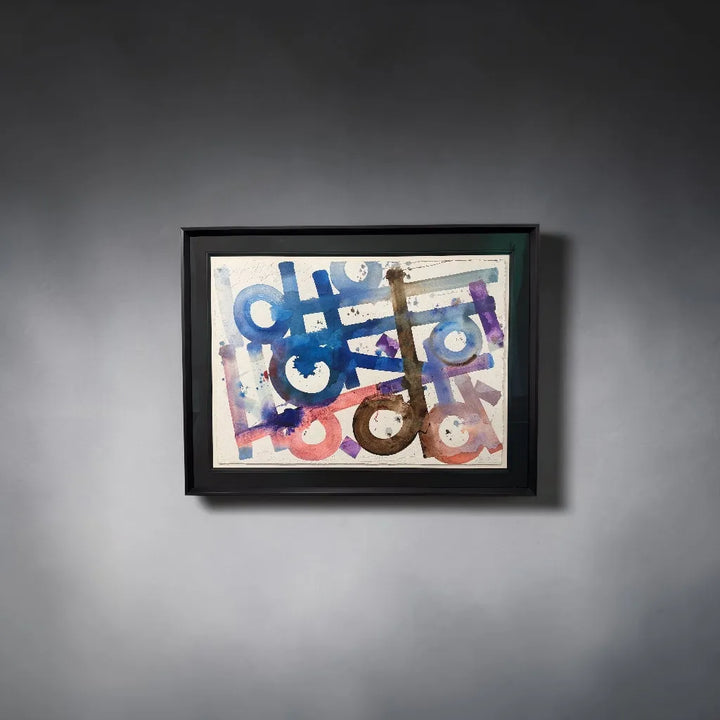 Framed abstract artwork by Retna with colorful geometric shapes on a grey wall