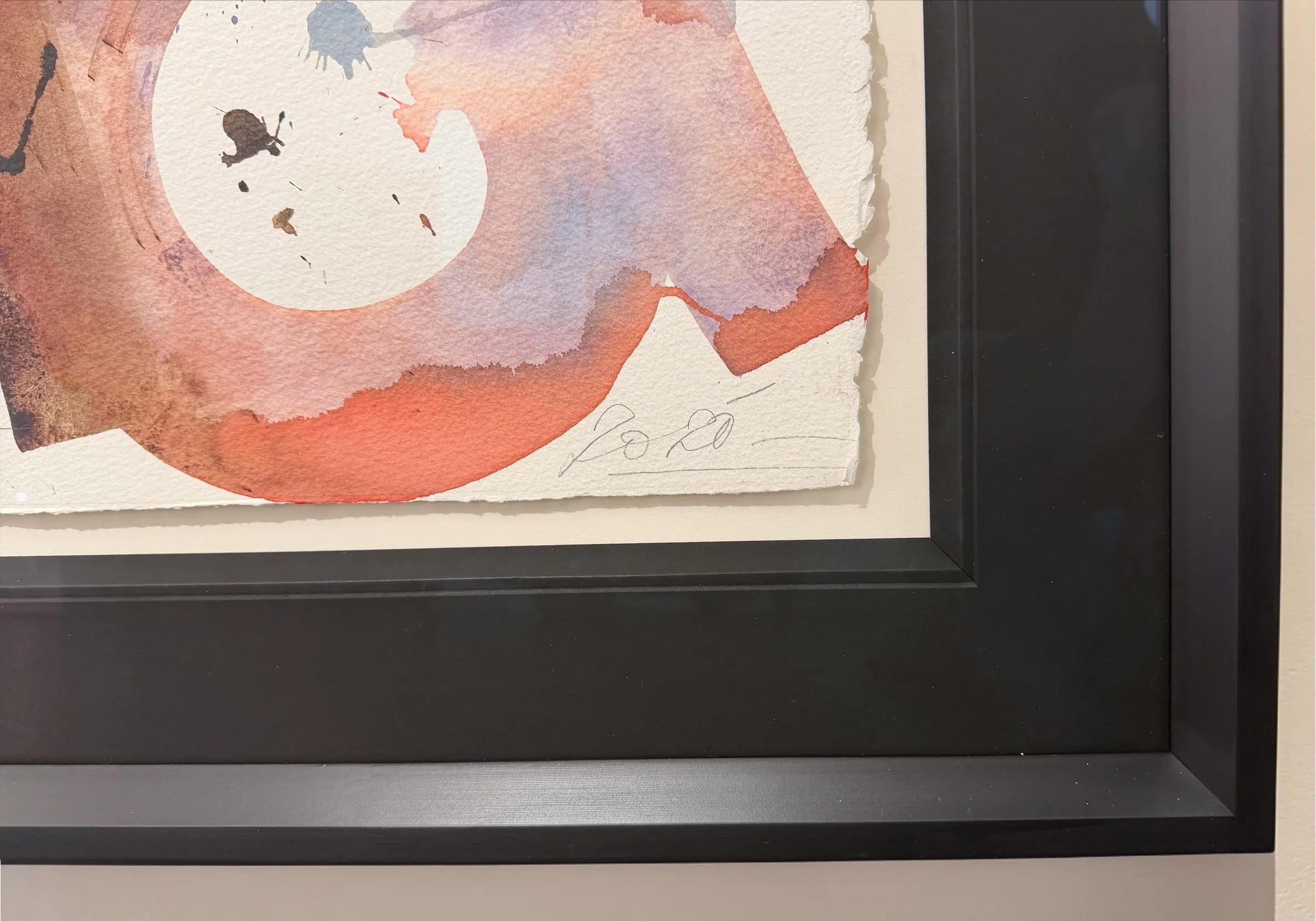 A close up of a corner of a Framed abstract artwork by Retna, showing the details with a black frame
