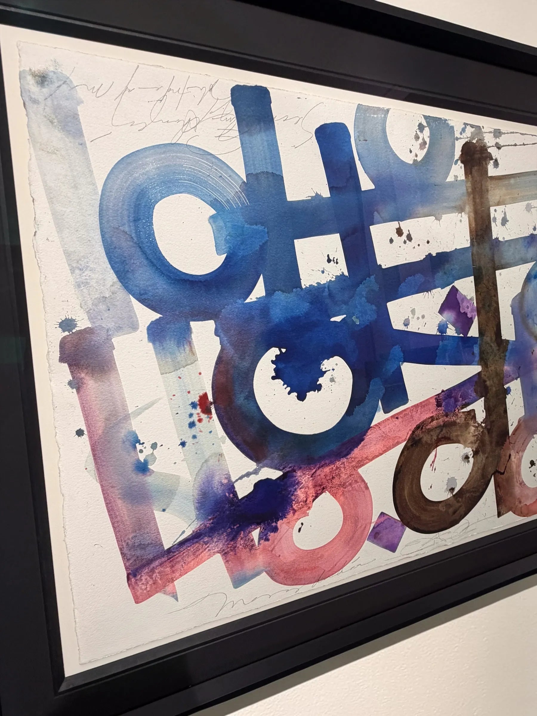 Colourful abstract artwork by Retna with splashes of blue, red, and brown in a black frame.