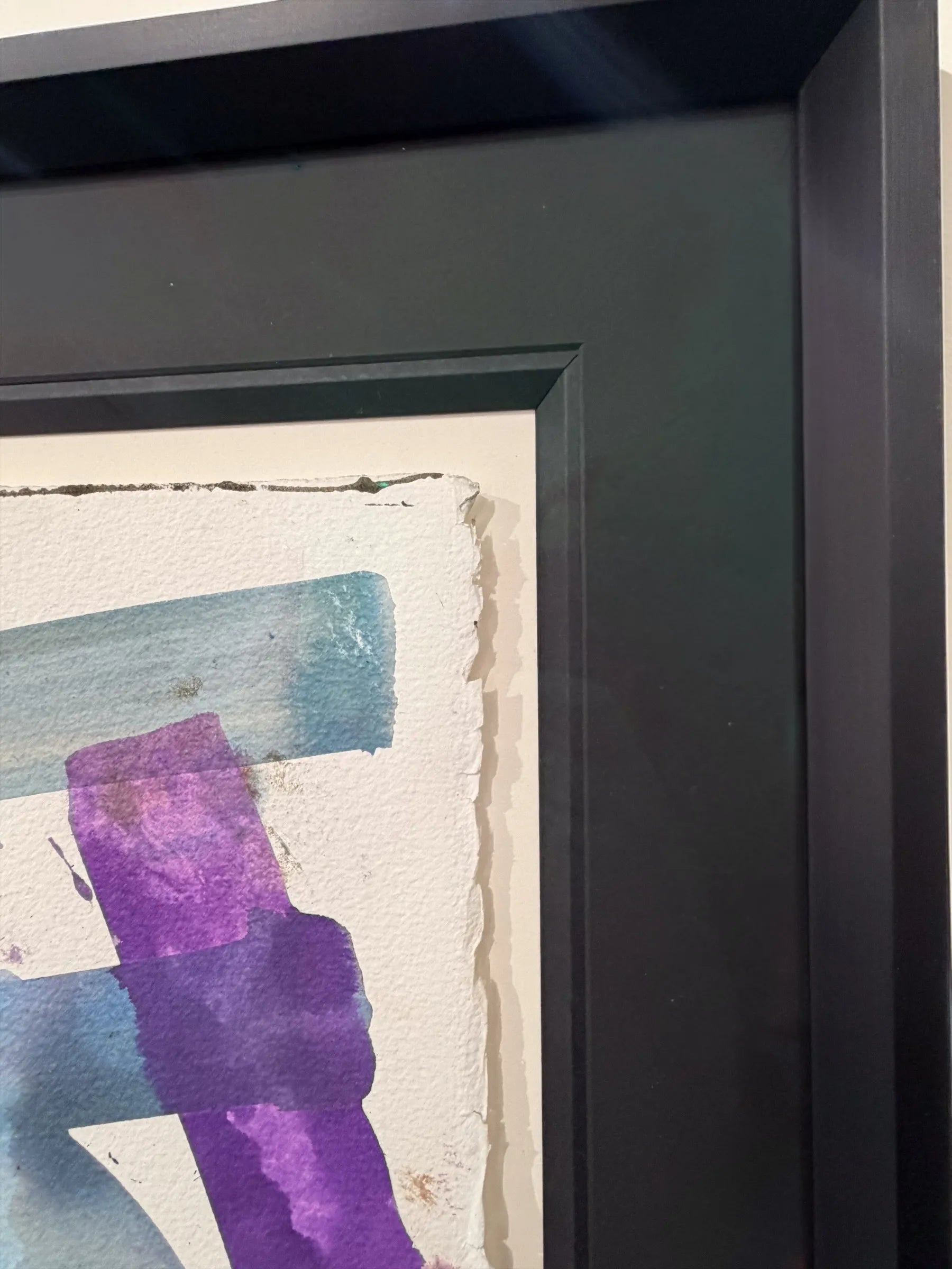 Framed abstract artwork with purple and blue strokes on a textured background