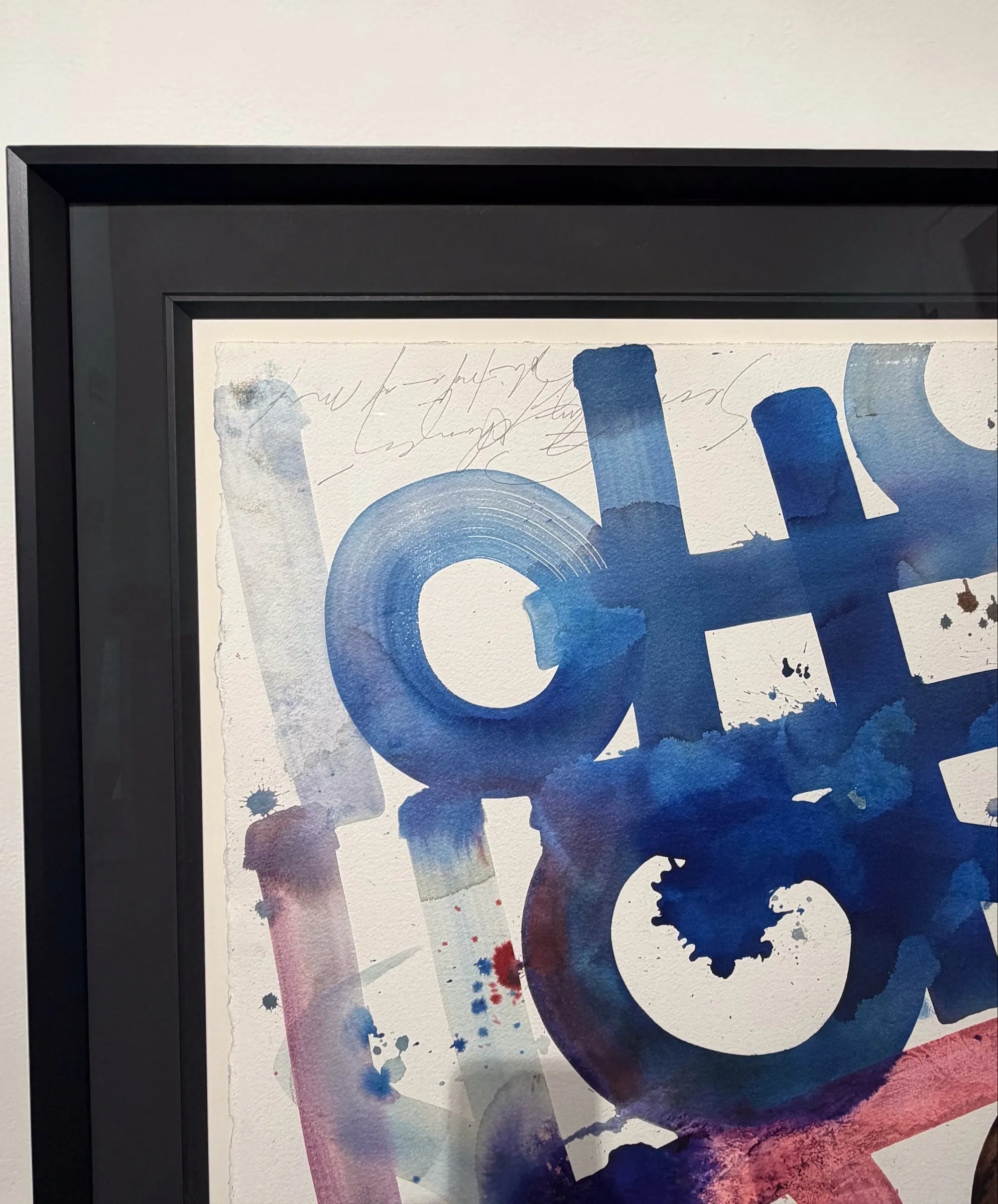 Framed abstract artwork by Retna with blue and red colours on a white background