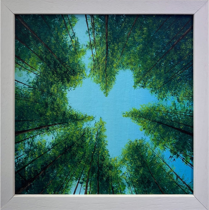 Framed artwork of a forest canopy by Vincent Devine  with a clear blue sky.