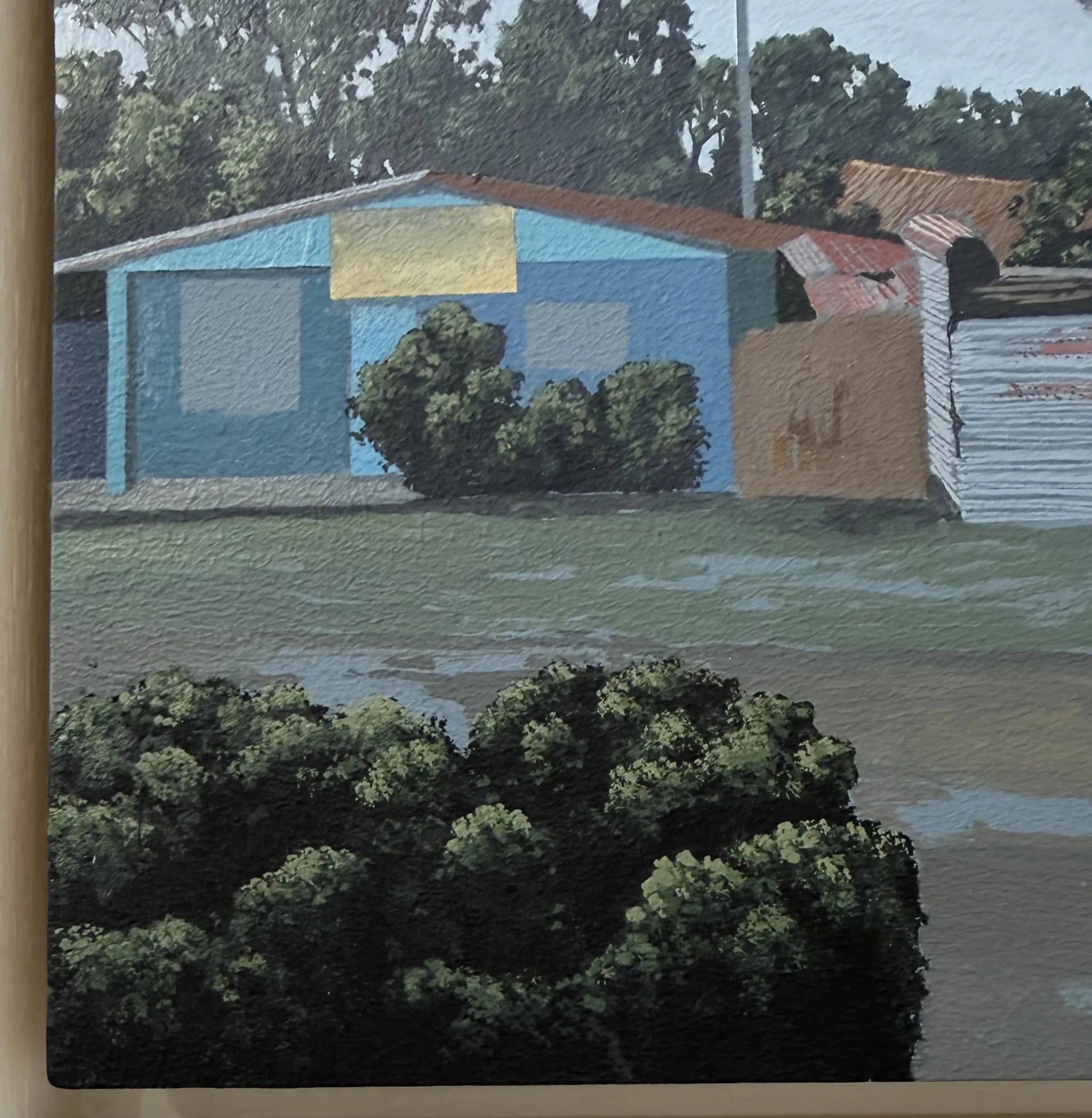 Painting of a blue house with a yellow roof and greenery in the foreground