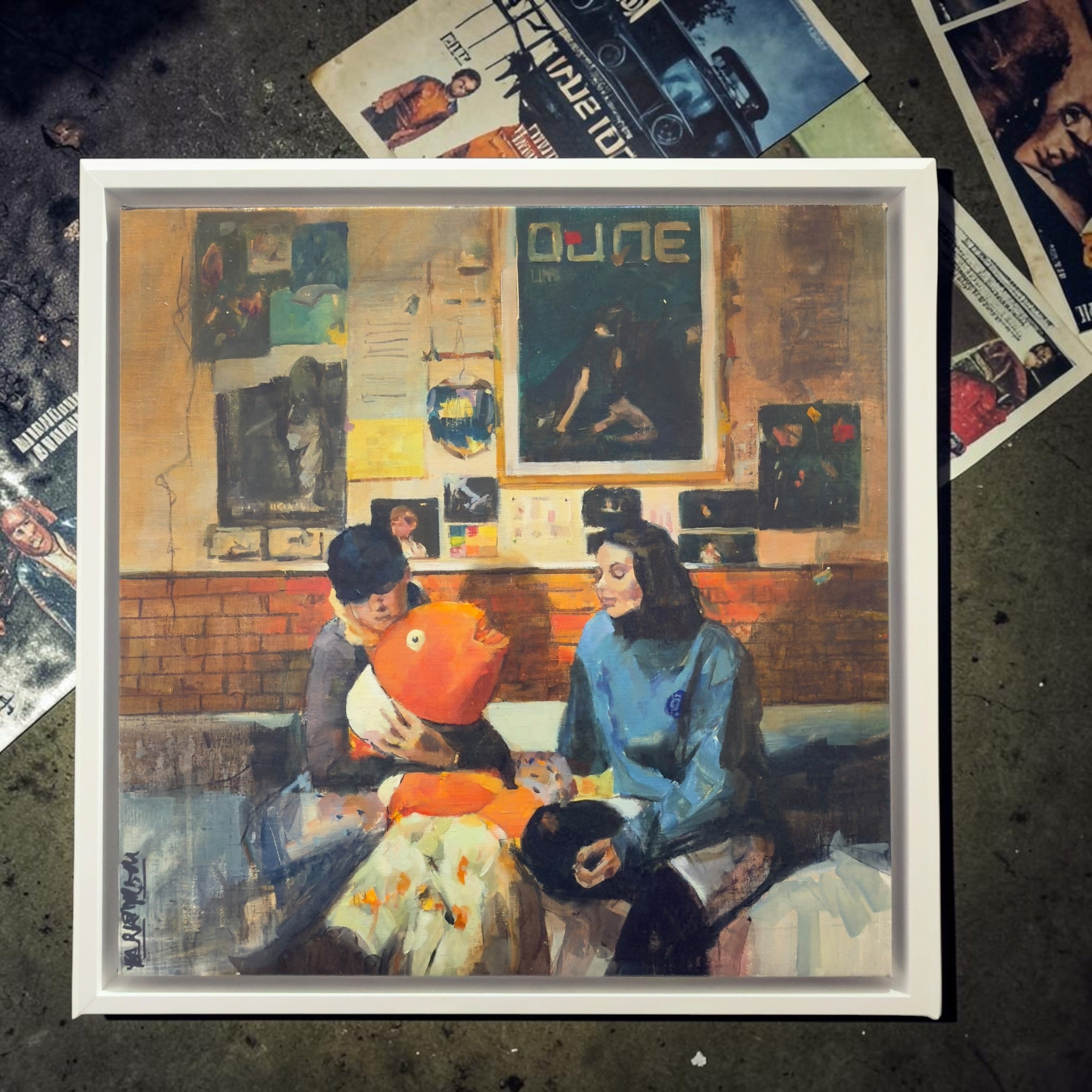 Framed oil painting by Mar Herrera titled "Nemo," featuring a playful orange fish and two figures in a contemporary setting