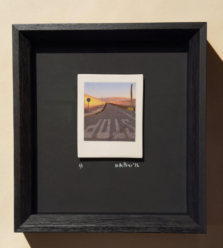 Framed incised photographic ceramic decal on porcelain titled "Nowhere Town" by artist Nadia Hillier, featuring a road scene with a "STOP" sign and real gold application