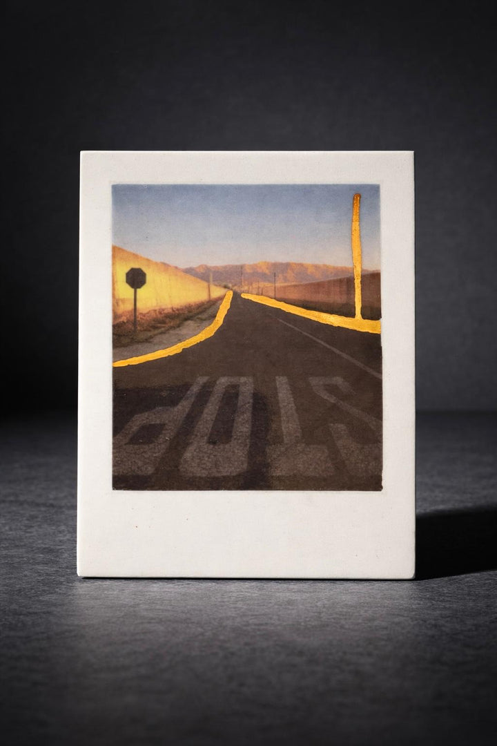 Incised photographic ceramic decal on porcelain titled "Nowhere Town" by artist Nadia Hillier, featuring a road scene with a "STOP" sign and real gold application